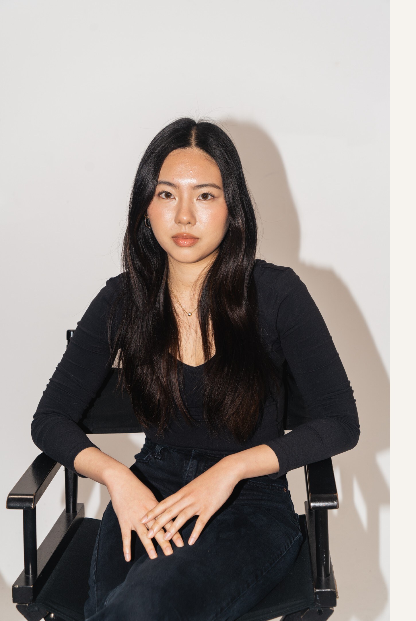 Portrait of Cheryl Wang seated against a neutral backdrop